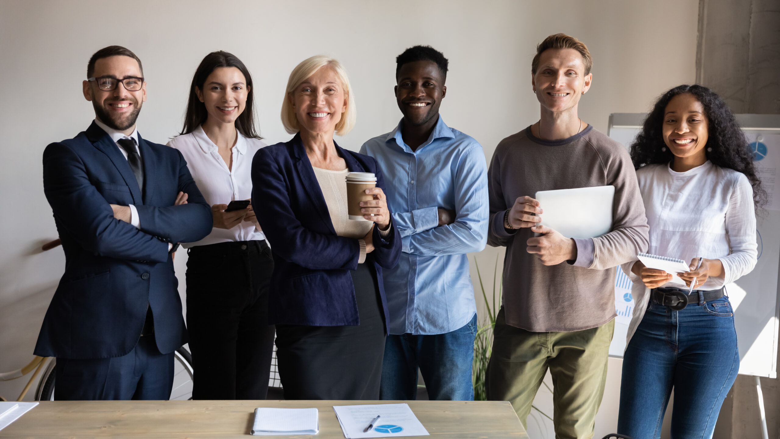 Home smiling diverse employees posing for corporate portrait in office together